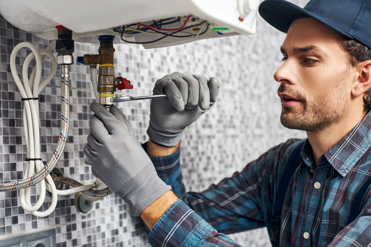 Wrench always with you. Worker set up electric heating boiler at home bathroom Hired & Non-Owned Auto Insurance